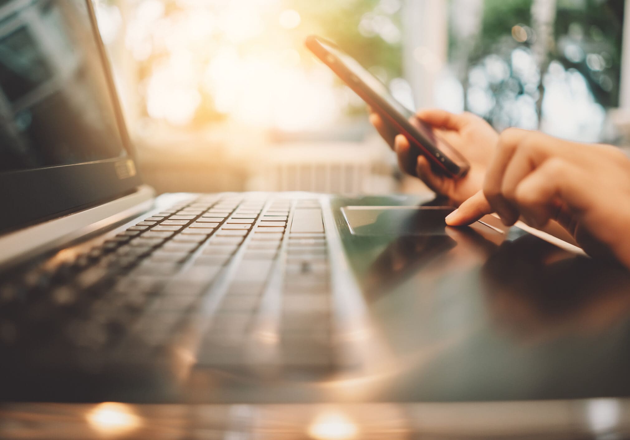 Woman hand using keyboard laptop on wood table in coffee shop. Business technology and freelance concept. Vintage tone filter effect color style.
