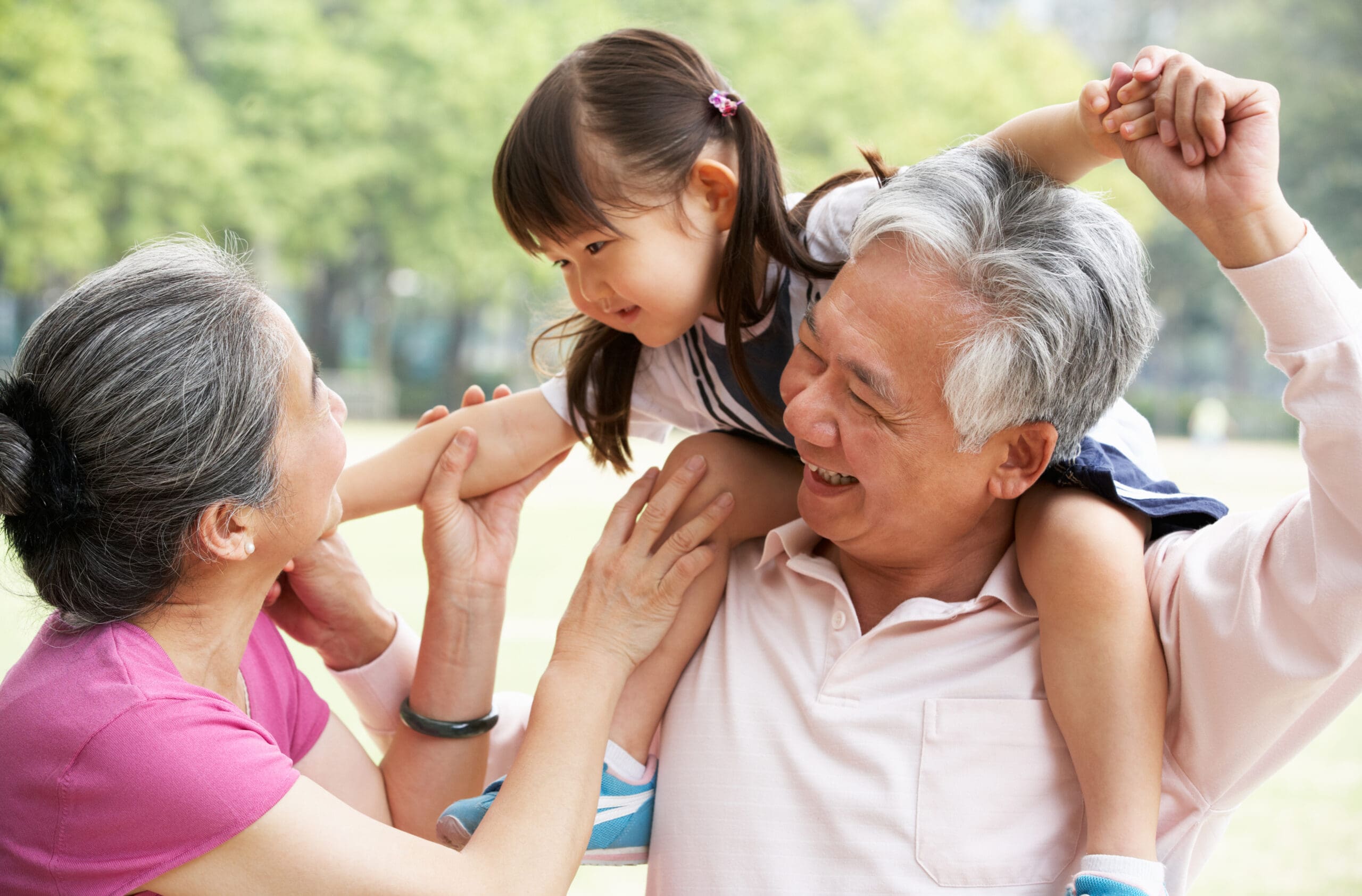 Chinese Grandparents Giving Granddaughter Ride On Shoulders Chinese Grandparents Giving Granddaughter Ride On Shoulders Smiling